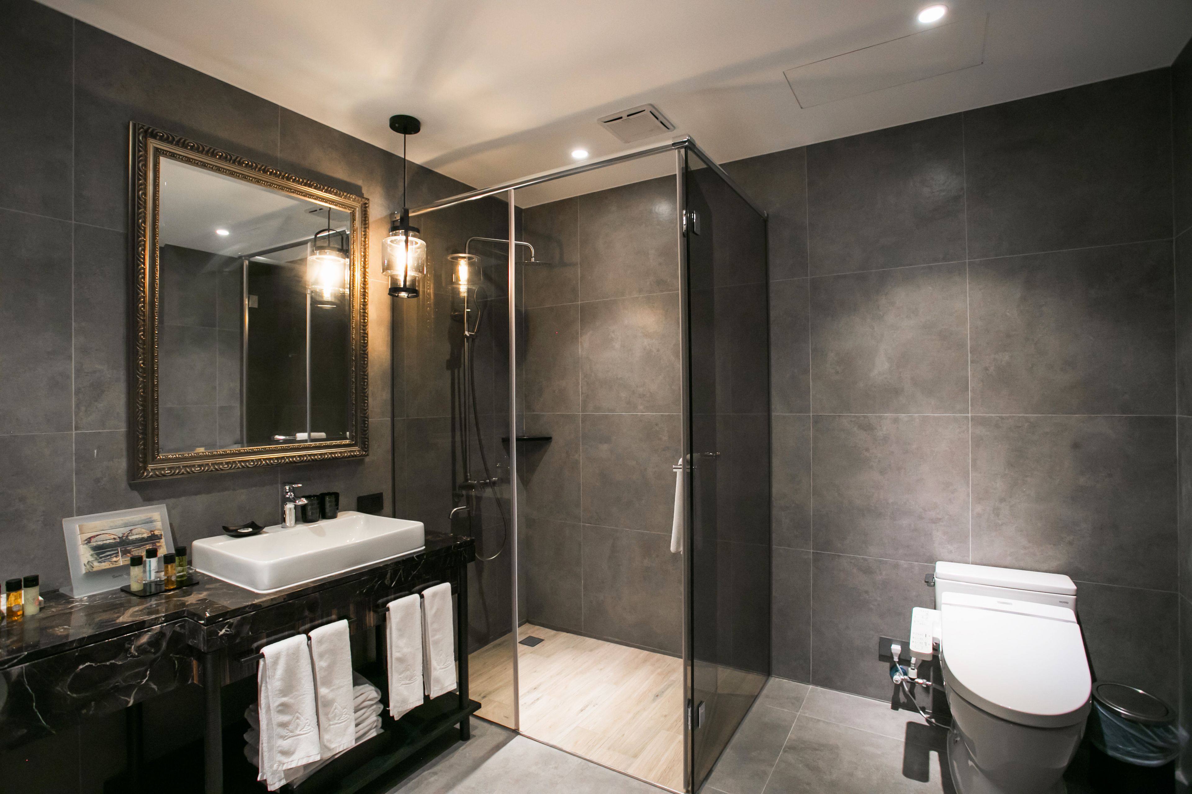 separate bathtub and shower, hair dryer, slippers, towels