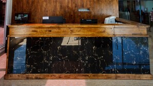 A reception desk with a wooden panel and a sign reading "SEOUL HOTEL". - Seoul Hotel Myanmar (Yangon)