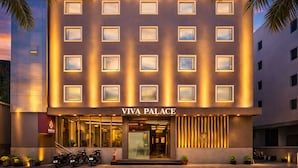 A multi-story building with a sign reading 'VIVA PALACE' at the entrance.