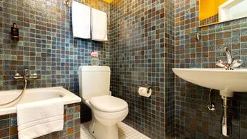 A bathroom with a white toilet, a white sink, and a bathtub.