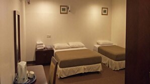A hotel room with two beds, a desk with a coffee maker, and a small cabinet. - Hotel Mercury (Kuala Lumpur)
