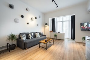 Lägenhet Executive - 1 sovrum - utsikt mot staden | Vardagsrum | 140-centimeters LED-tv med kabelkanaler, tv och Netflix