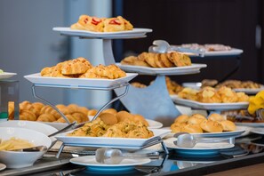 A buffet with various baked goods and pastries on tiered serving stands. - Grand Majestic Hotel (Kuwait City)