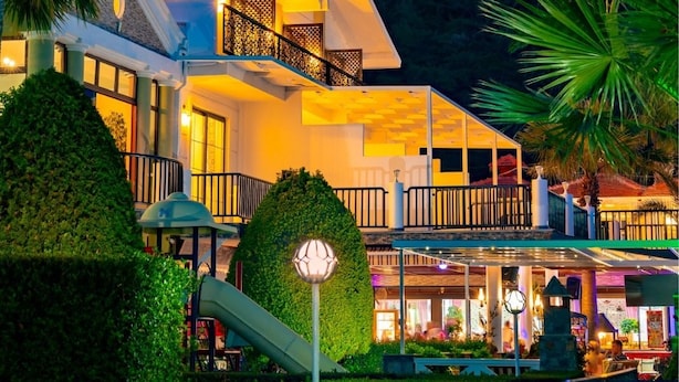 A modern hotel with a balcony, a play area, and a view of a mountainous landscape. - Hotel Karbelsun (Fethiye)