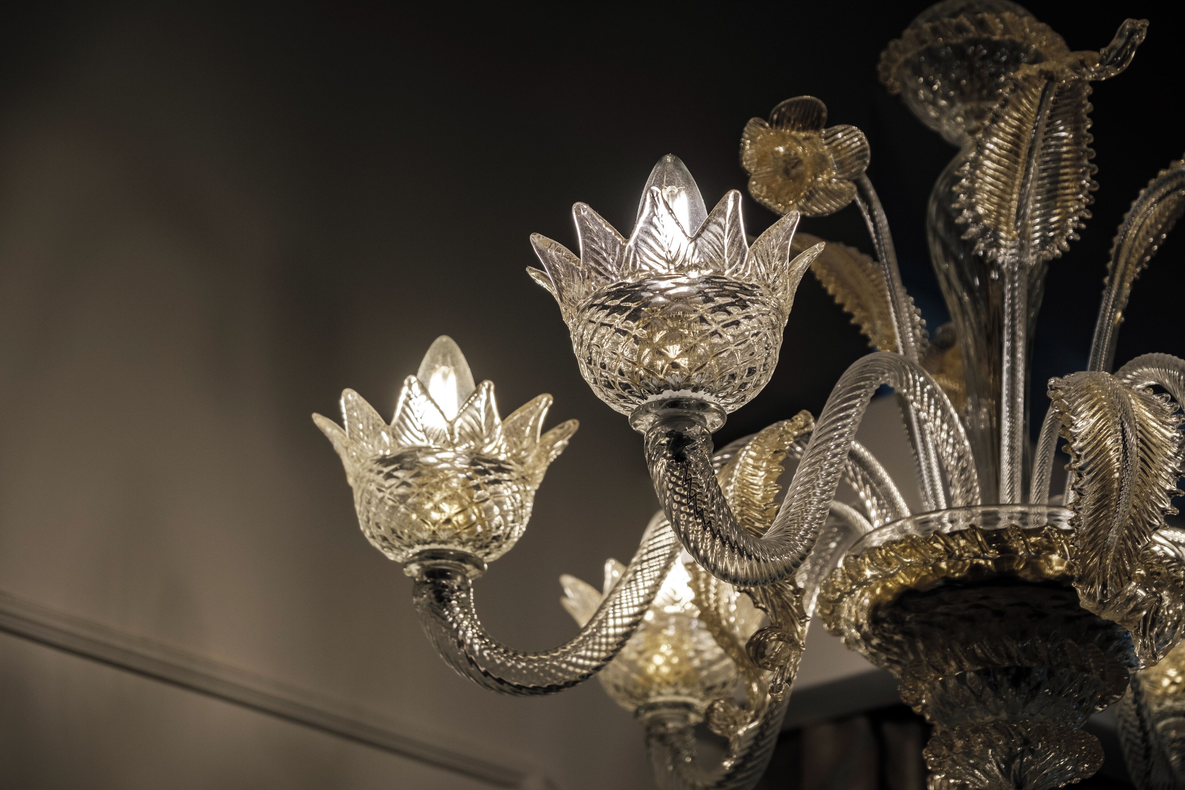 A chandelier with intricate crystal designs and multiple light sources.