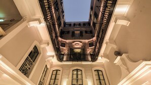 A high-ceilinged atrium with ornate balconies and large windows. - Domus Zamittello (Valletta)