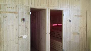 A wooden room with a door leading to a darker space.