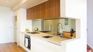 Casa executiva, 3 quartos, cozinha, vista para a cidade | Cozinha privada | Geladeira grande, fogão, cooktop, talheres/pratos/utensílios de cozinha