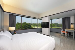 Relax in a spacious room with a large bed, floor-to-ceiling windows, and a flat-screen TV.