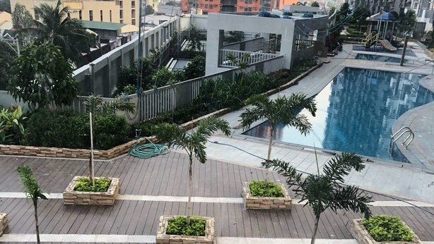 A rooftop pool area with a view of high-rise buildings in the background. - Cubao ManhattanHeights Unit 4Q Tower D (Quezon City)