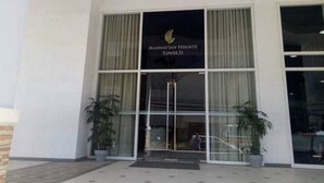 A building entrance with a sign reading "MANHATTAN HEIGHTS TOWER D". - Cubao ManhattanHeights Unit 4Q Tower D (Quezon City)
