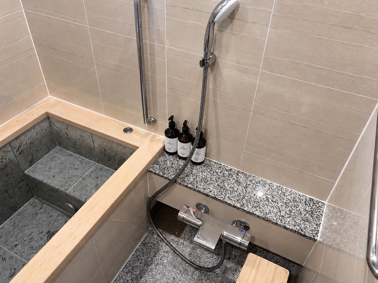 A bathroom with a bathtub, a shower, and a sink.