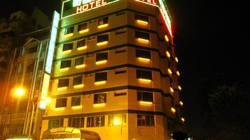 A multi-story hotel with illuminated signage and a prominent entrance.
