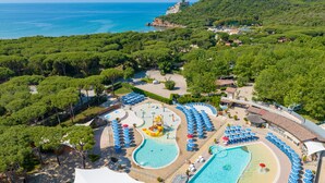 A resort with multiple swimming pools, a water park, and a beach area.