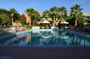 Piscine extérieure, parasols de plage, chaises longues