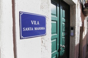 A blue sign with white lettering on a white wall, reading "VILA SANTA MARINHA." - Villa Sta.Marinha (Lisbon)