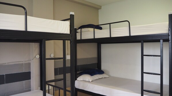 A bunk bed room with a ladder, a power outlet, and a pillow on the lower bunk. - Leo Backpackers Central Market (Kuala Lumpur)