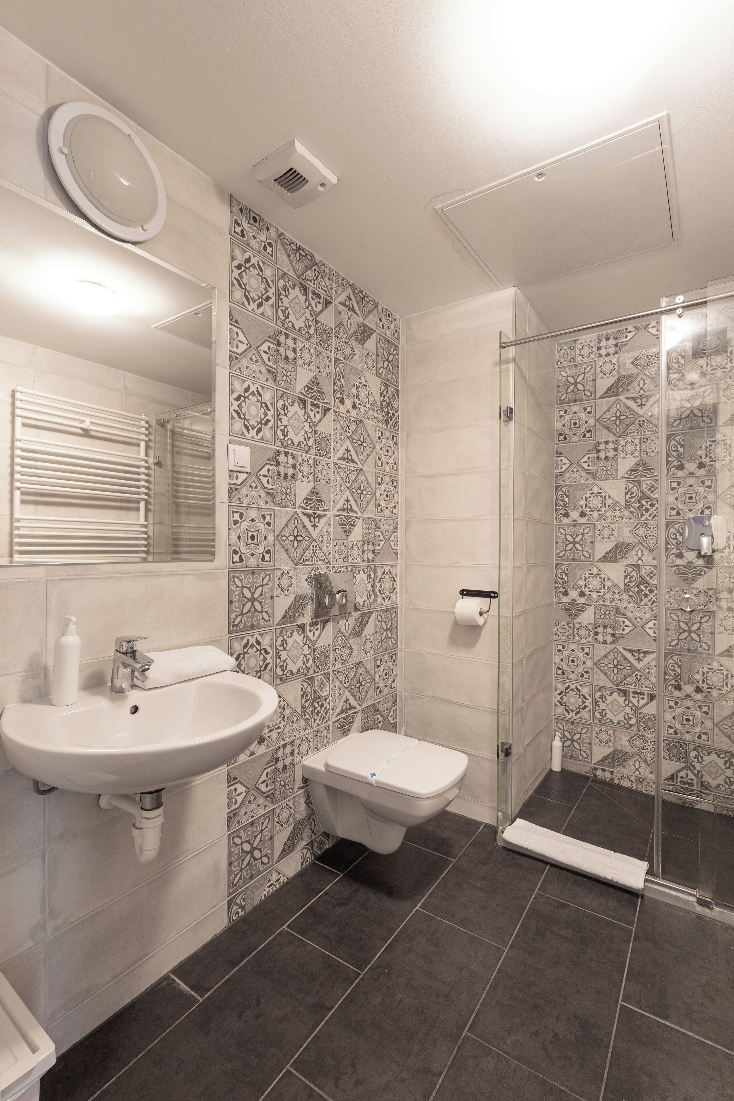 A bathroom with a sink, toilet, and shower.