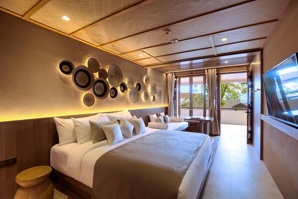 A modern hotel room with a large bed, a wall-mounted circular light fixture, and a TV.