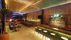 An outdoor bar area with wooden ceiling, seating, and a bar counter. - City Centro by Marriott Oaxaca (Oaxaca)