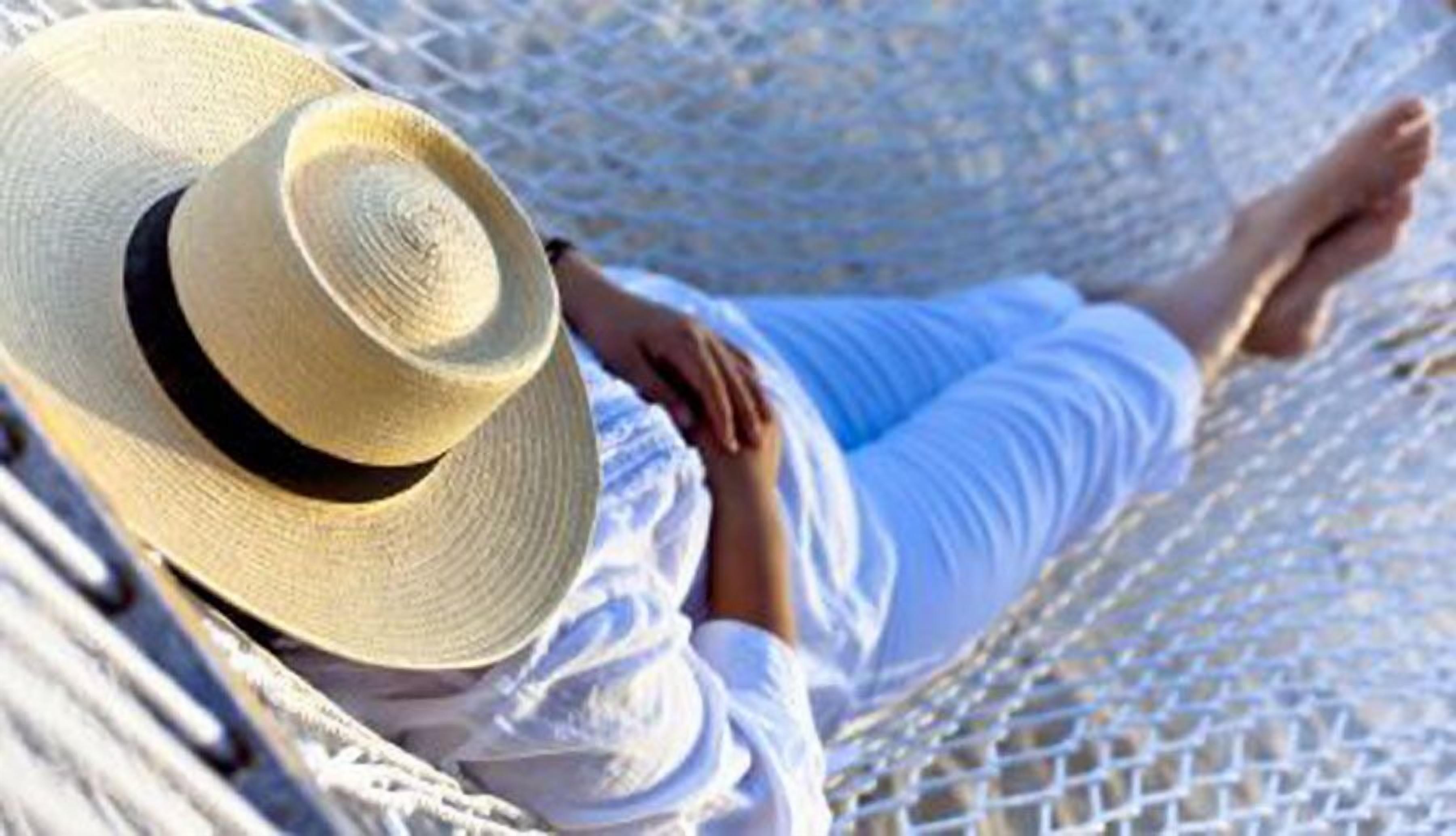 A person lying in a hammock.