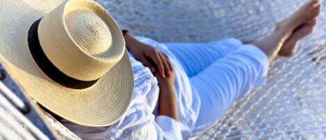 A person lying in a hammock.