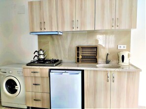 Apartment, 1 Bedroom | Private kitchen | Fridge, stovetop, electric kettle, cookware/dishes/utensils