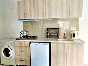 Apartment, 1 Bedroom | Private kitchen | Fridge, stovetop, electric kettle, cookware/dishes/utensils