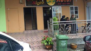 A hotel named 'Golden Night' with a tiled entrance and a metal railing.