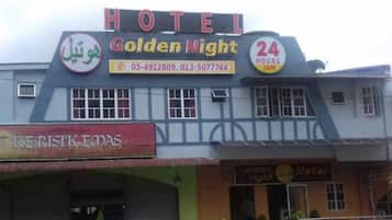 A hotel named "Golden Night" with a sign indicating 24 hours operation.