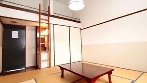 A traditional Japanese room with tatami flooring, a low wooden table, sliding doors, and a ladder leading to a higher level. - Lodge Christmas Rose ZAO (Yamagata)