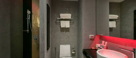 A modern bathroom with a shower, toilet, and sink.