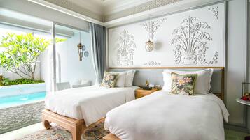 A hotel room with two beds, a large window with a view of a pool, and a decorative wall with floral patterns.