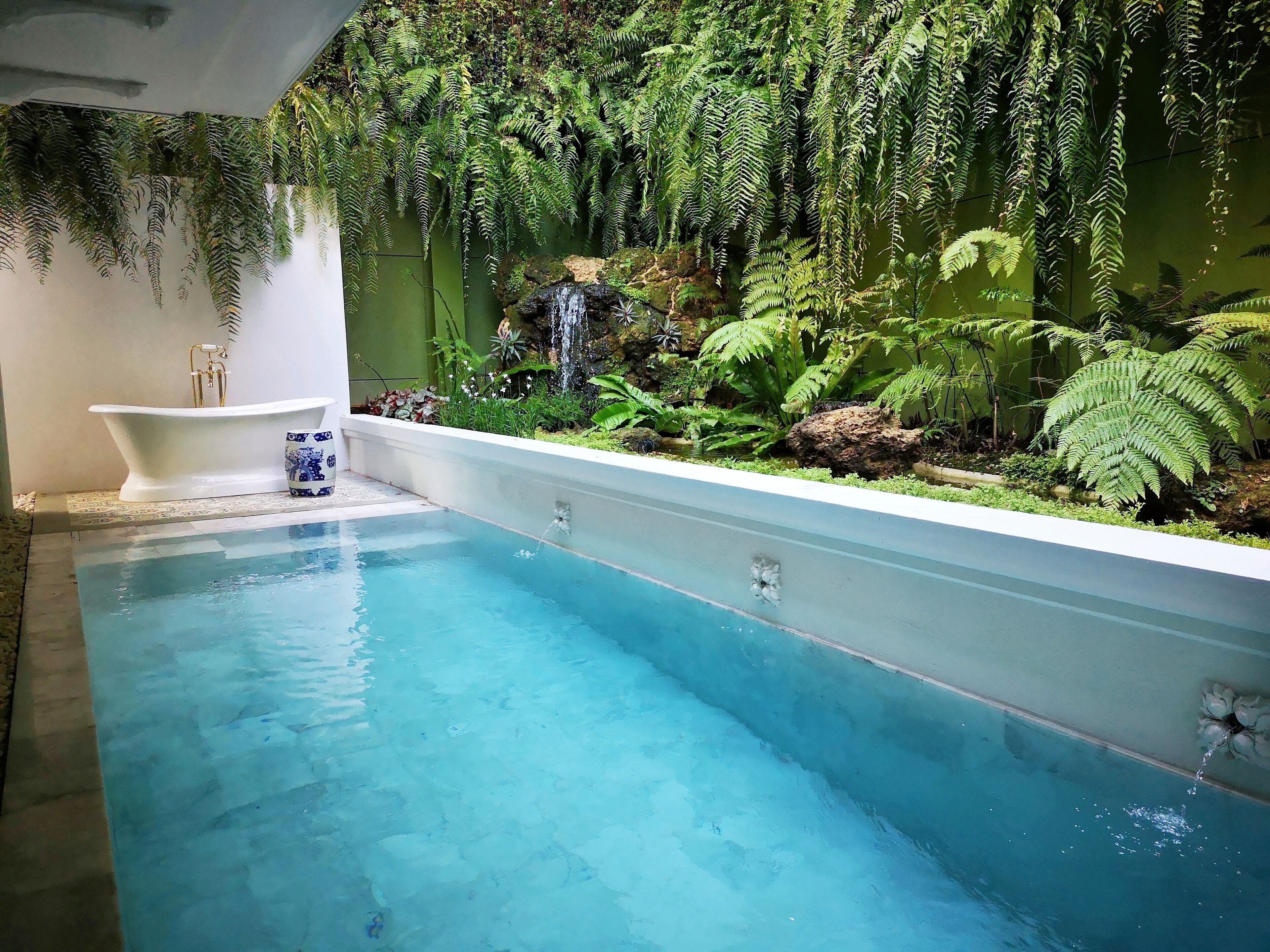 A pool with a white tub and a blue decorative item.
