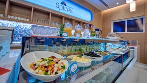 A buffet area with a variety of food options, including fruits, cheeses, and juices. - Al Khoory Inn (Dubai)