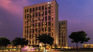 A tall hotel building with a modern facade, multiple windows, and a prominent 'Loft Hotels' sign. - Aloft by Marriott Me’aisam, Dubai (Dubai)