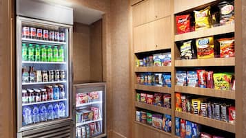 A storage area with shelves stocked with snacks and beverages.