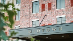 A brick building with the name "MIDTOWN" on the facade. - Hotel Indigo Hattiesburg by IHG (Hattiesburg)
