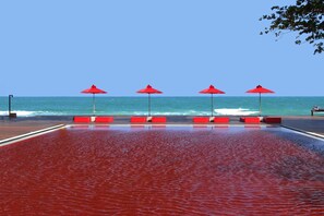 Relax by the ocean with a pool and beach seating areas.