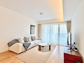 City View 2 Bedroom Cozy Family Suite | Living room | 55-inch TV with cable channels, smart speakers - Tyms High Serviced Residence Shanghai Xujiahui Metro (Shanghai)