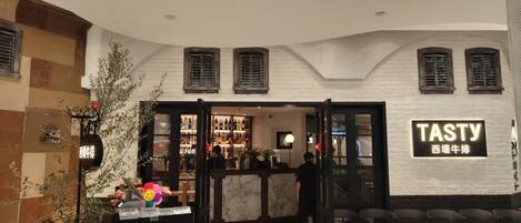 A Tasty restaurant with a modern interior, a bar area, and a seating section.