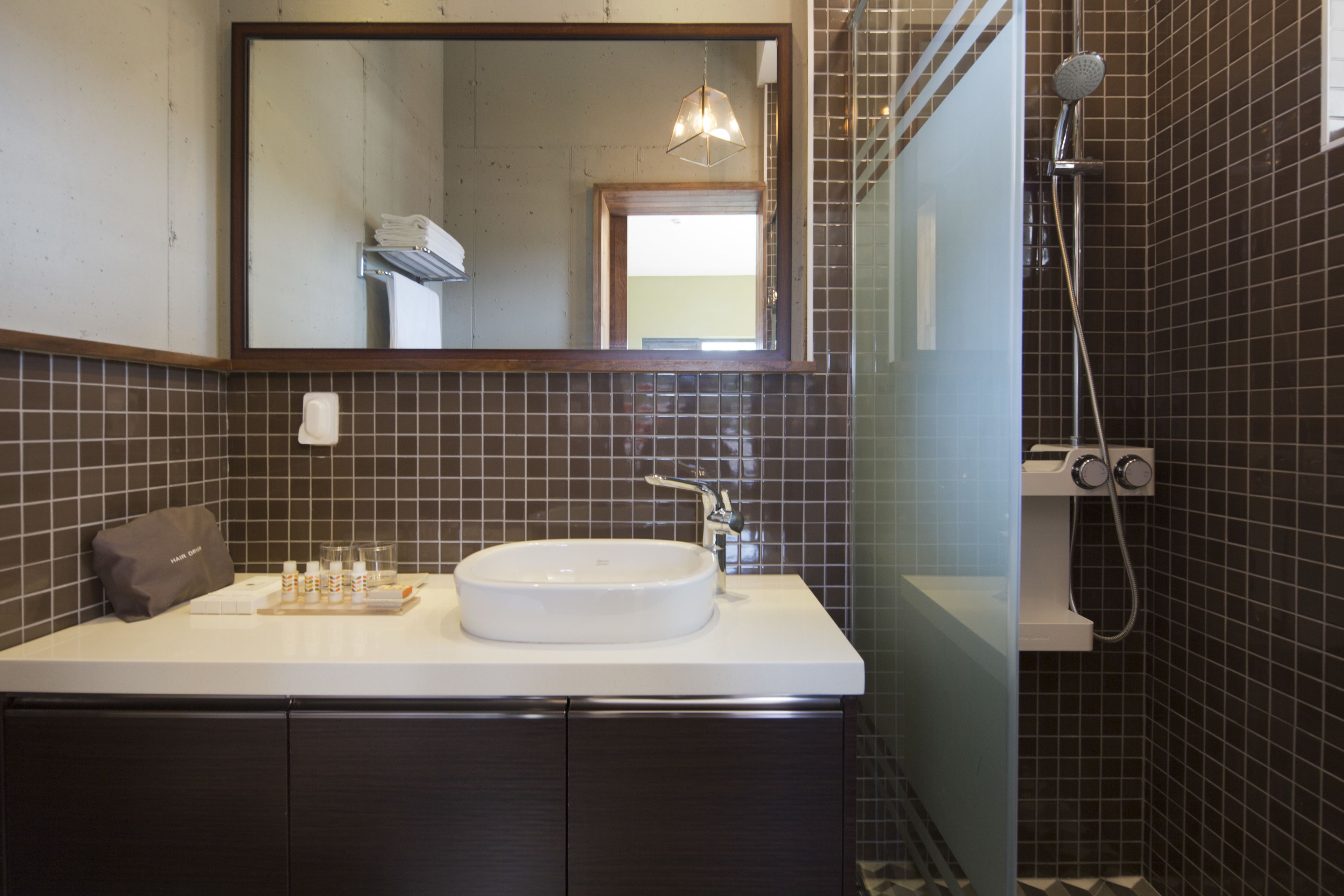 corner suite | bathroom | combined shower/bathtub, designer toiletries, hair dryer, slippers