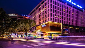 A multi-story hotel with illuminated signage and a prominent entrance. - Guangzhou Kardon Hotel Gorgeous (Guangzhou)