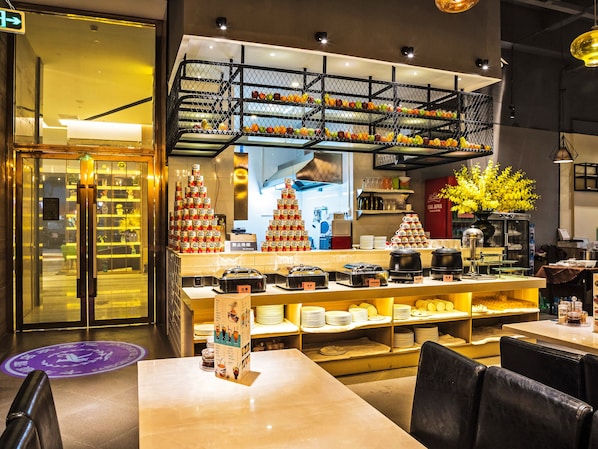 A restaurant interior with a sushi bar, seating area, and a display of various food items.
