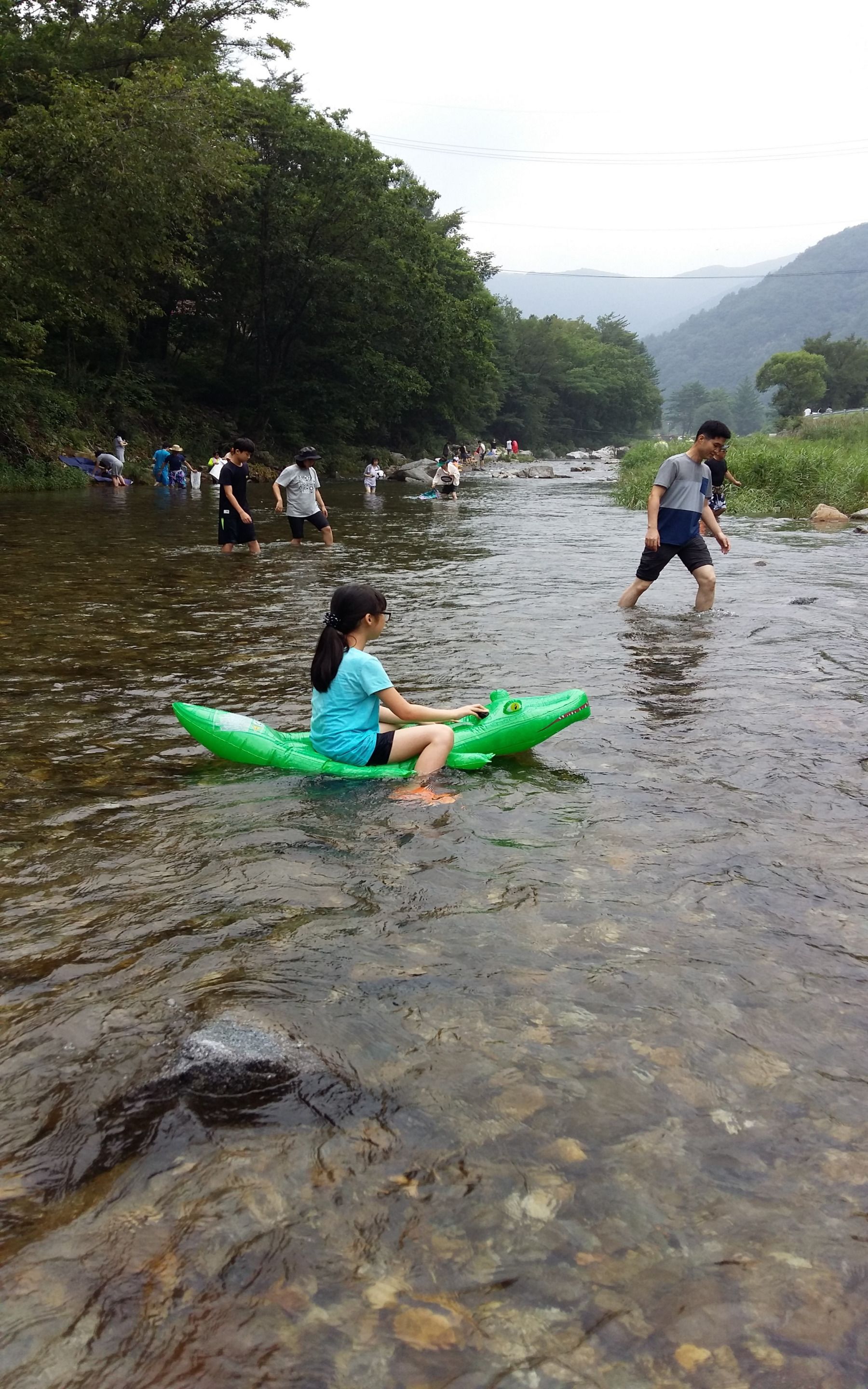 A river scene with people engaging in water activities.