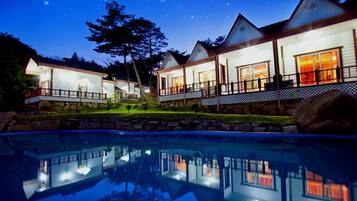 Seasonal outdoor pool, a natural pool, pool umbrellas, sun loungers