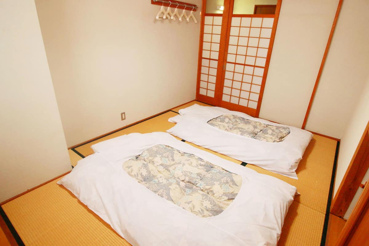 A traditional Japanese room with tatami flooring and shoji screens.