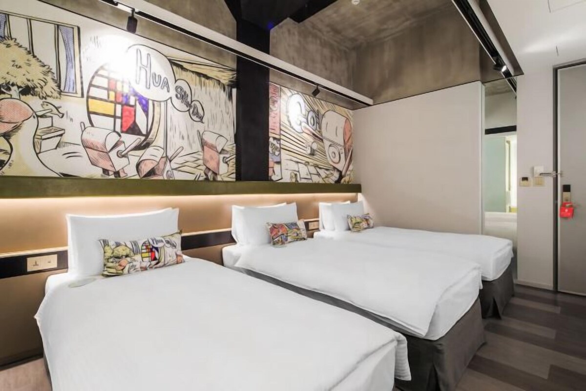 A hotel room with two beds, a mural on the wall, and a modern design.