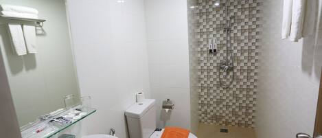 A bathroom with a bathtub, toilet, and shower.