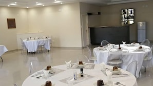 A conference room with multiple tables set for a meeting. - Tsumeb Guesthouse Kamho (Tsumeb)